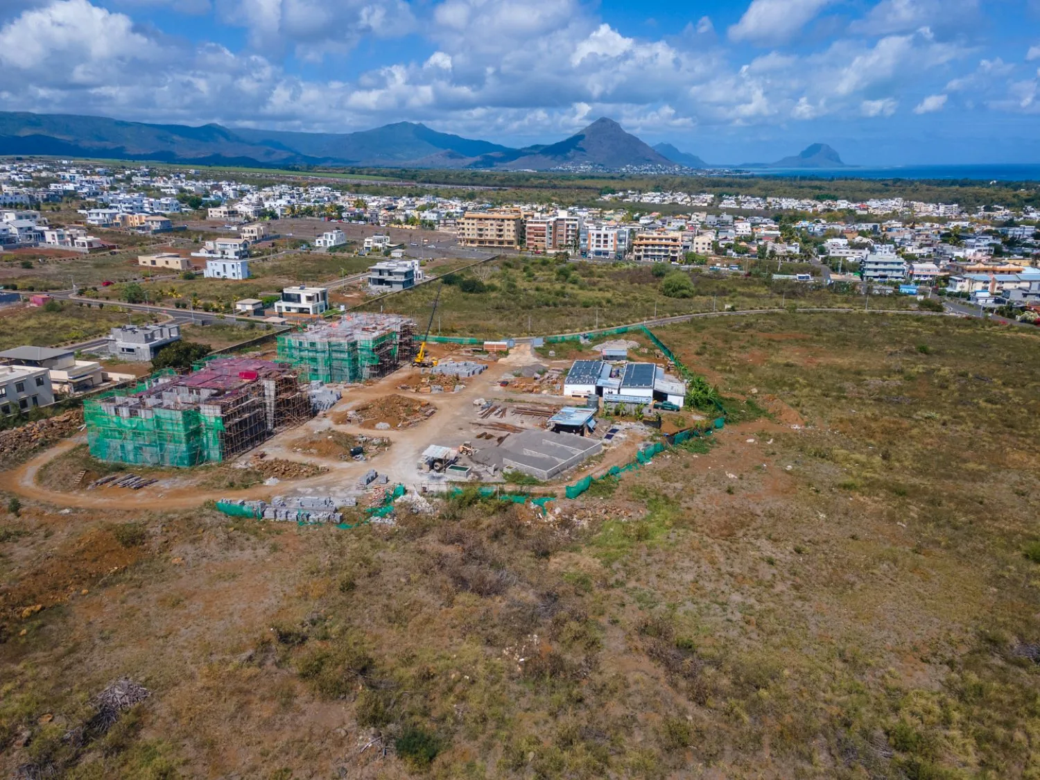High aerial view placing the Anna City site between the residential streets of Anna and the west-coast mountains