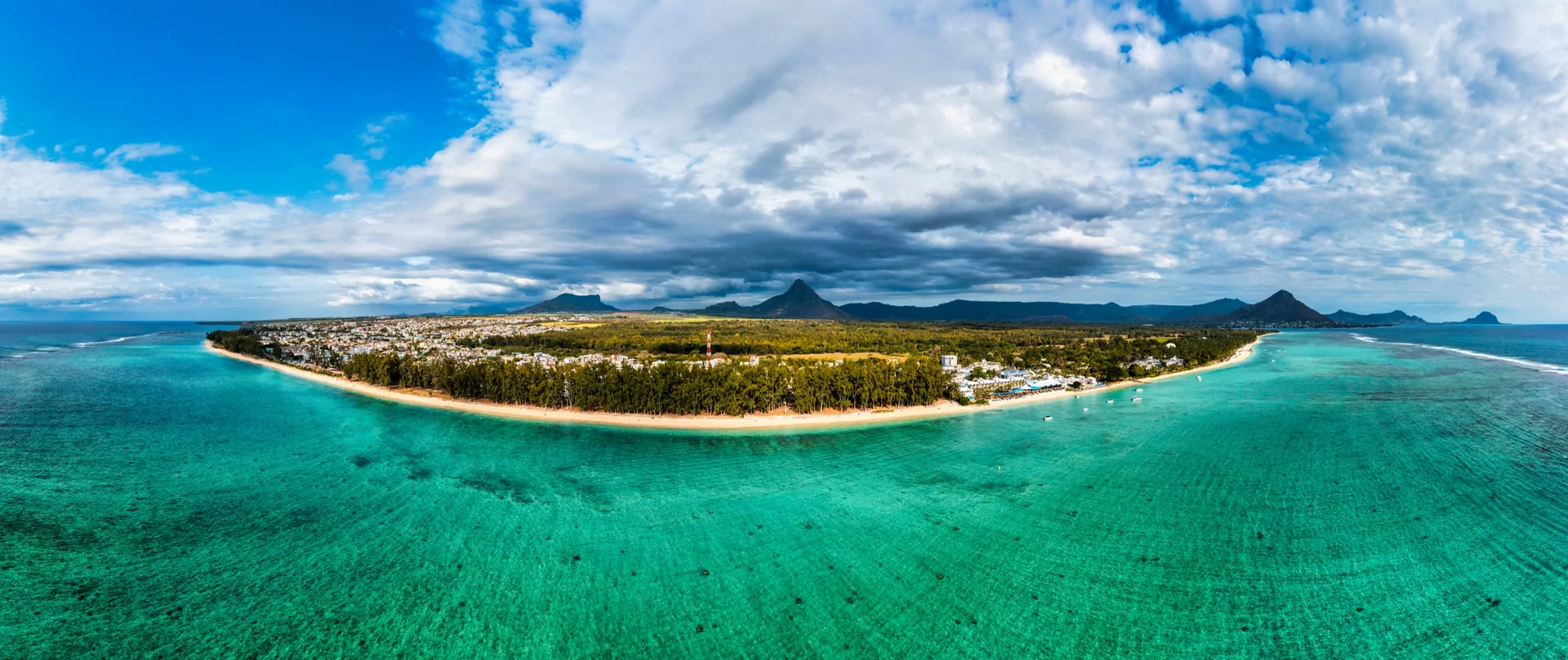 Panoramic aerial view of the Flic en Flac coastline and mountains, the west-coast setting for Anna City